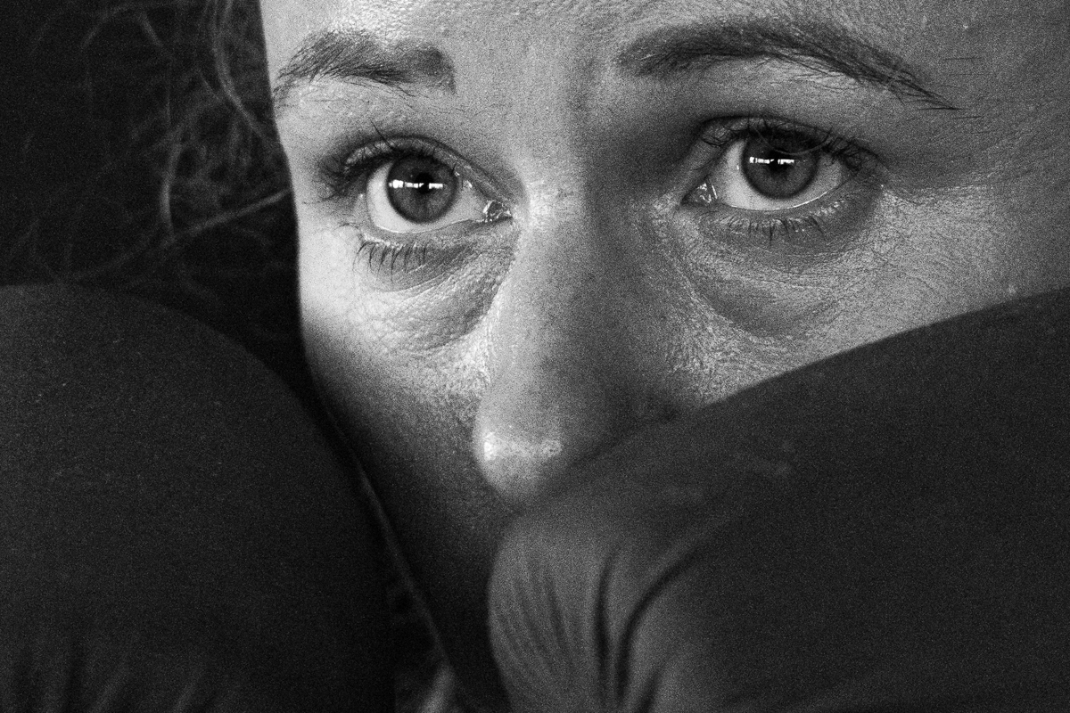Nahaufnahme eines Boxers/Boxerin mit Handschuhen im Ringside Gym in Lichtenberg, Berlin. Der Fokus liegt auf dem Gesicht des Sportlers/der Sportlerin.